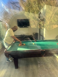 Husband in the ADU playing pool