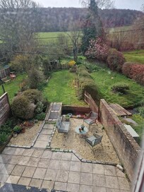 Back garden with little bridge over the river.