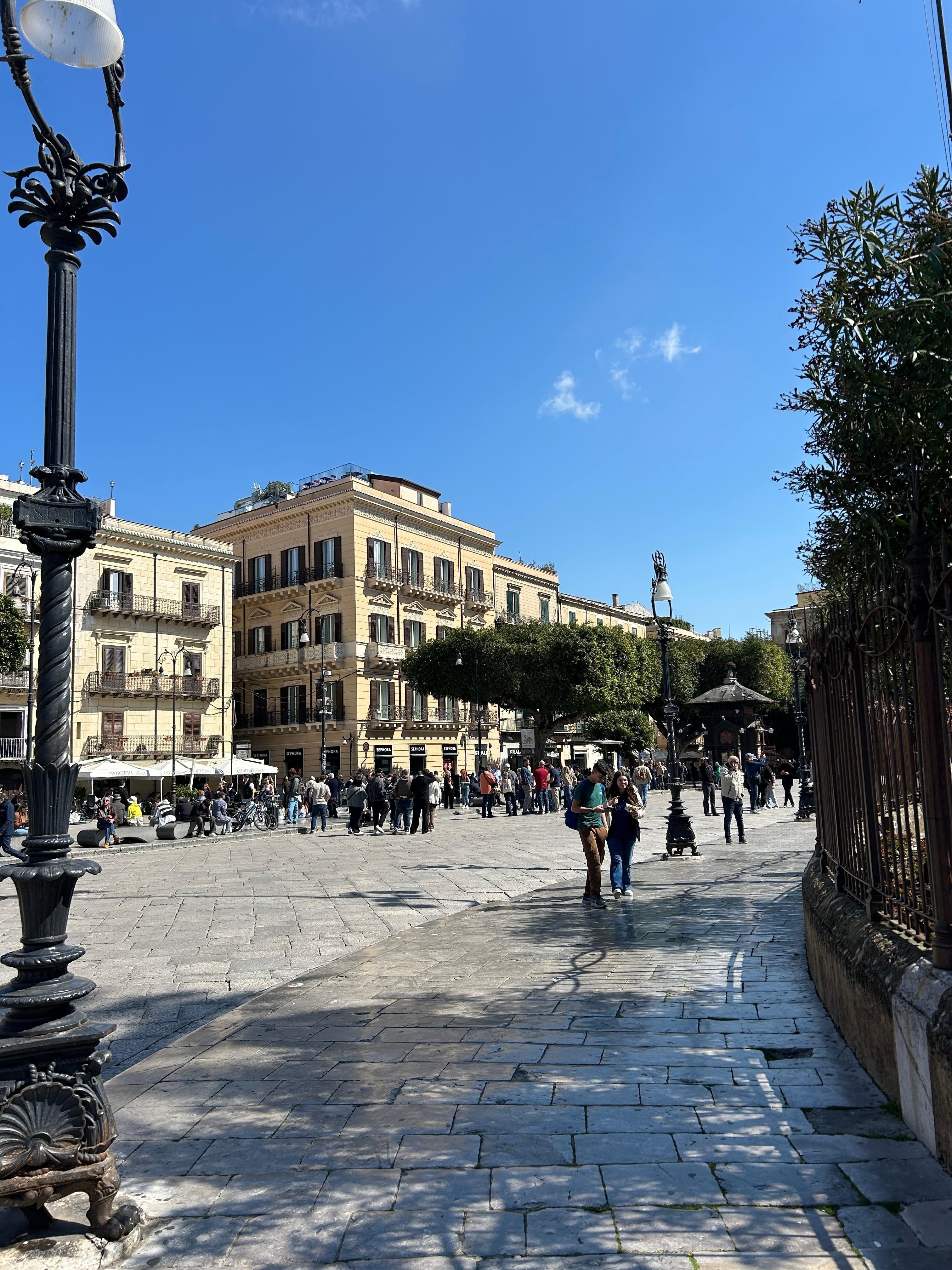 The Palazzo is the building on the right with its entrance on the small side street! It faces the Opera House.  The Cafe is in the smaller building with the white awning across from it. 