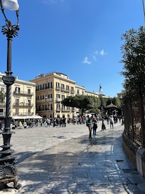 The Palazzo is the building on the right with its entrance on the small side street! It faces the Opera House. The Cafe is in the smaller building with the white awning across from it.