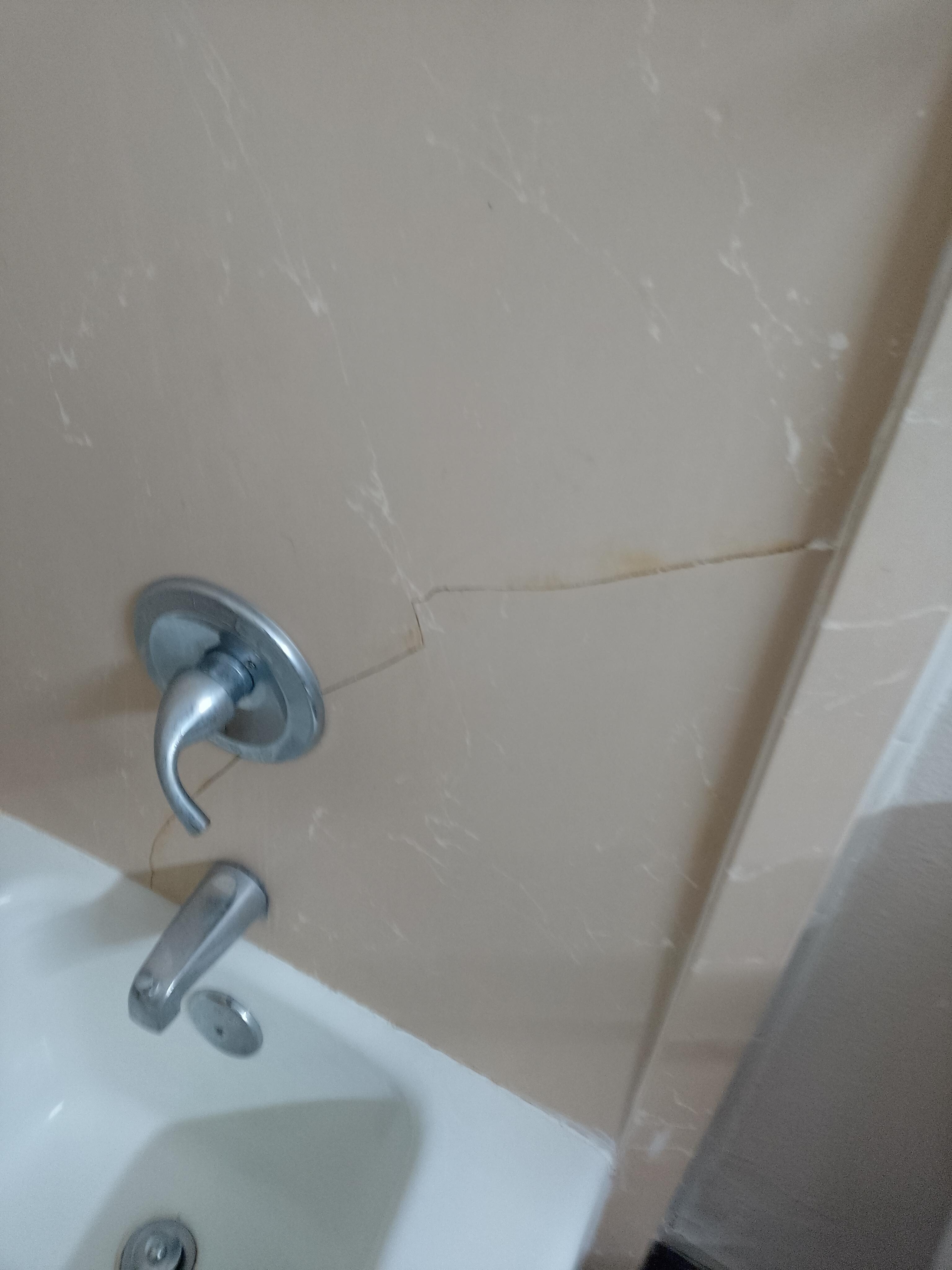 Cracked wall in shower area.