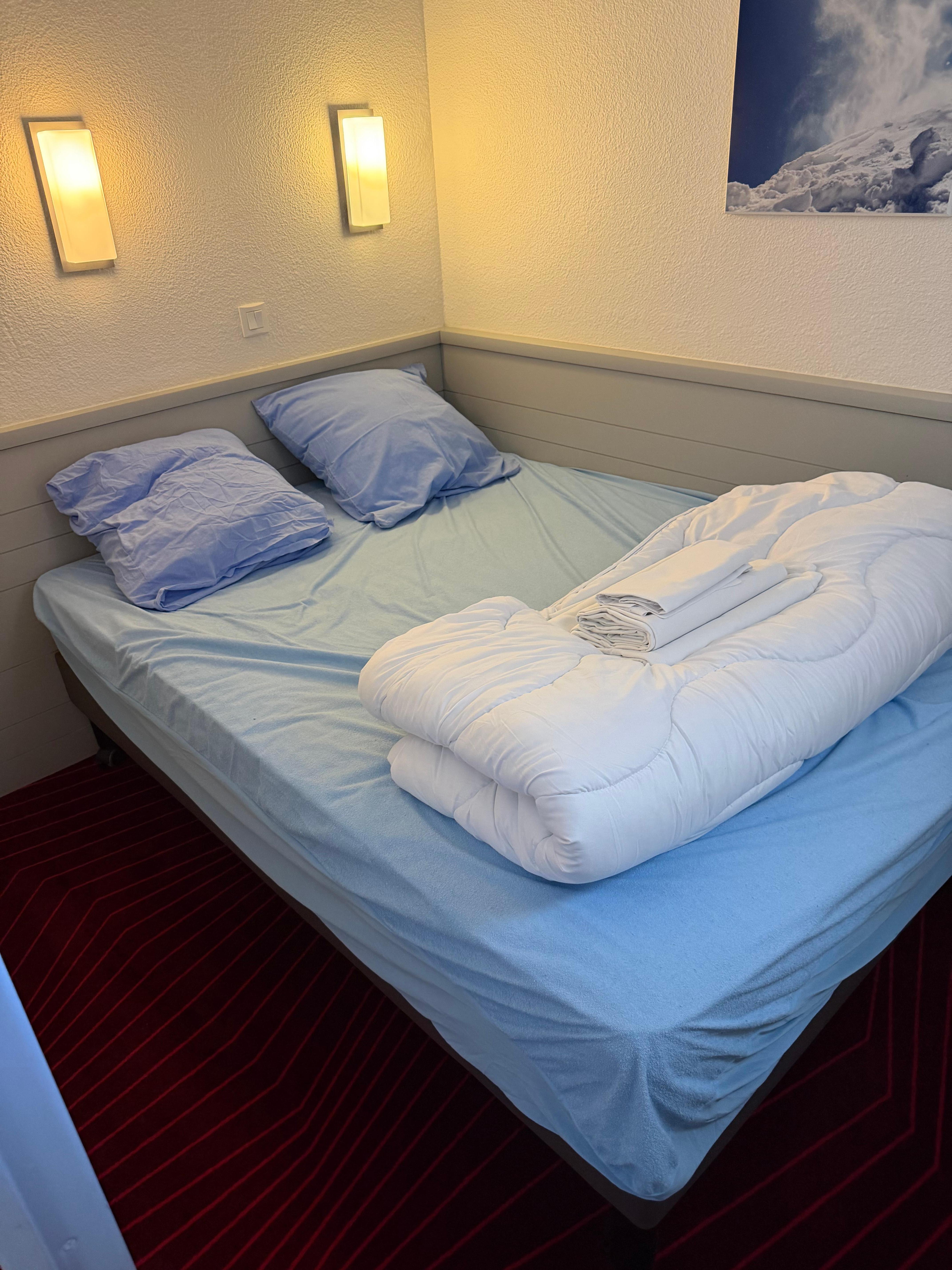 Tiny bedroom without even a bedside table. 