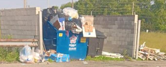 Trash right next to building at Knight's Inn