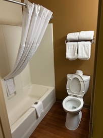 clean bathroom with many towels and soap,