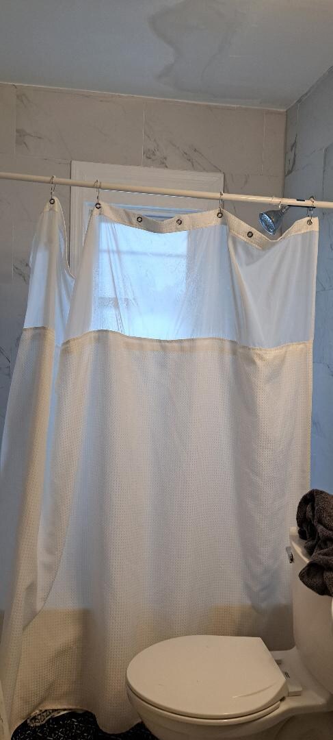 "Spa bathroom?" 3 shower curtain hooks, stains on ceiling; other toilet not working correctly