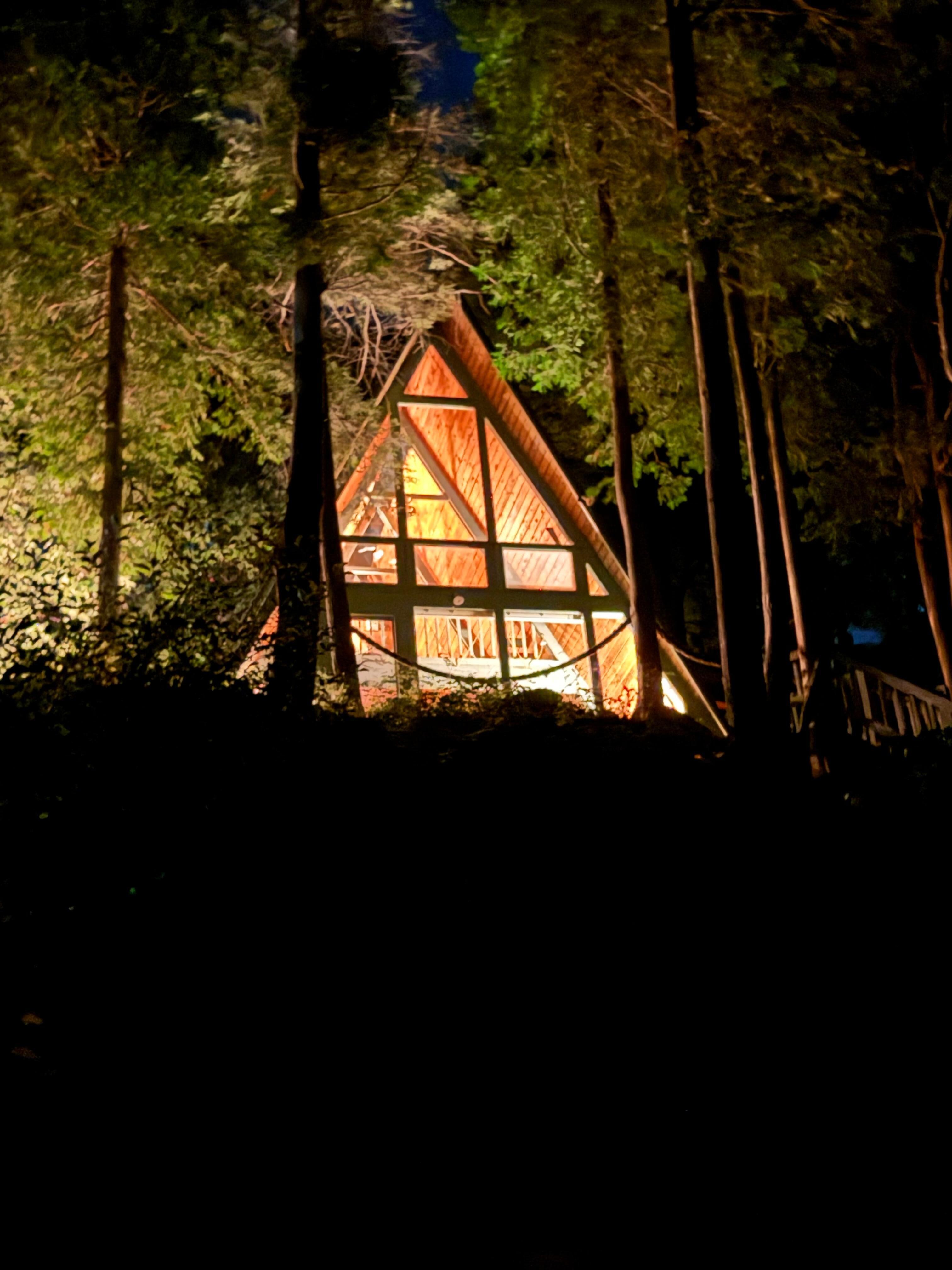 Photo of the A-Frame lit up at night. 