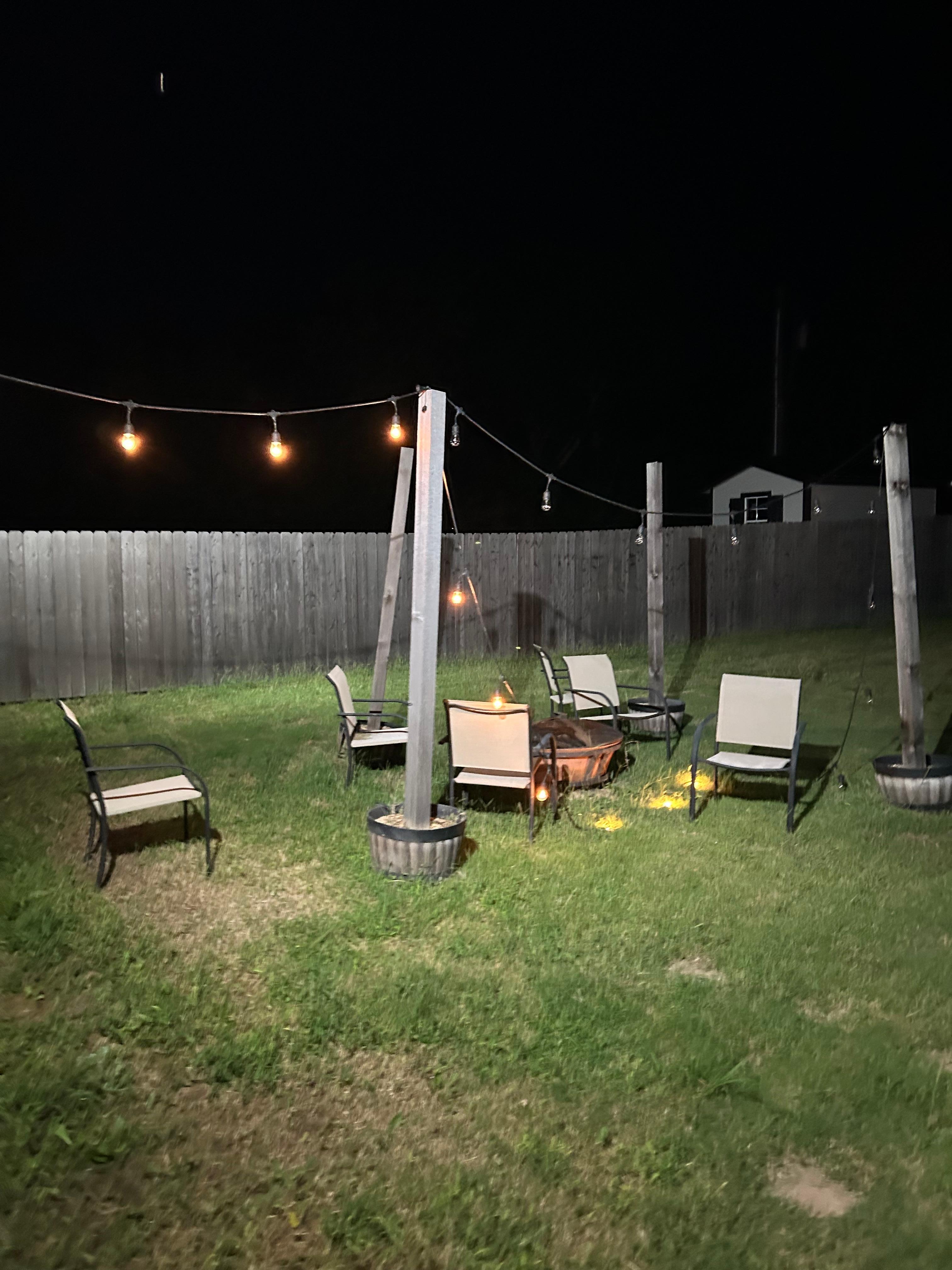 Lights on the ground and unmanicured  yard.