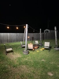 Lights on the ground and unmanicured yard.