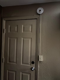 Smoke alarm taken apart and bent up door