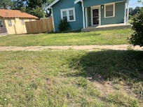 Front yard unkept & no seating on porch