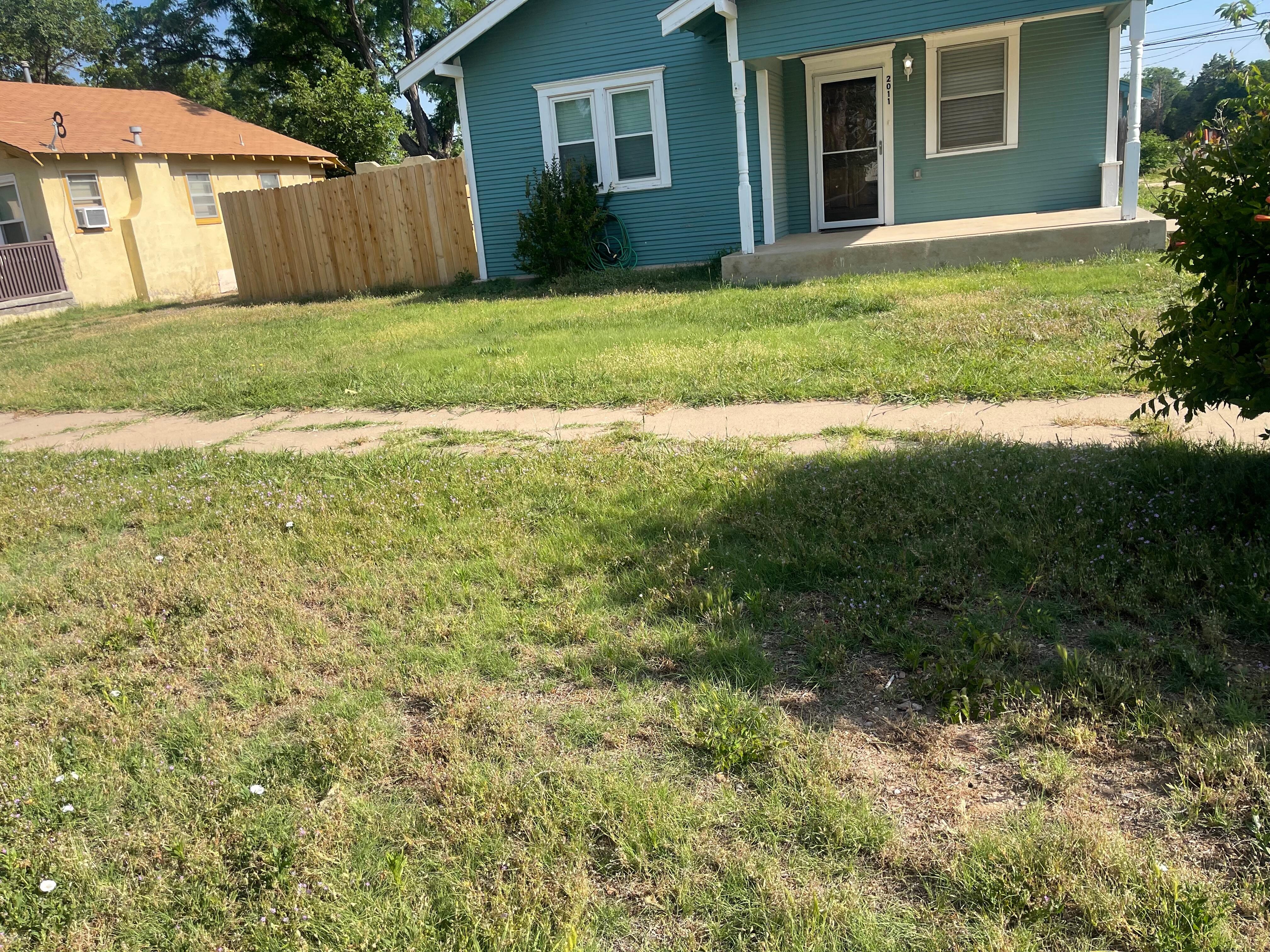 Front yard unkept & no seating on porch