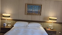 For reasons unknown the bed is not centered with the wall frame and this was an upgraded room!