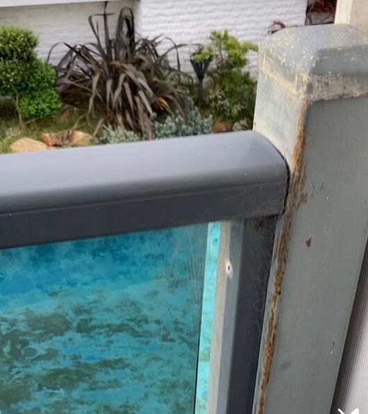 Filthy pool and rusty poles. Also pool gate is propped open with a rock