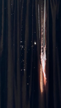 The curtain had burn holes where the light shines thru