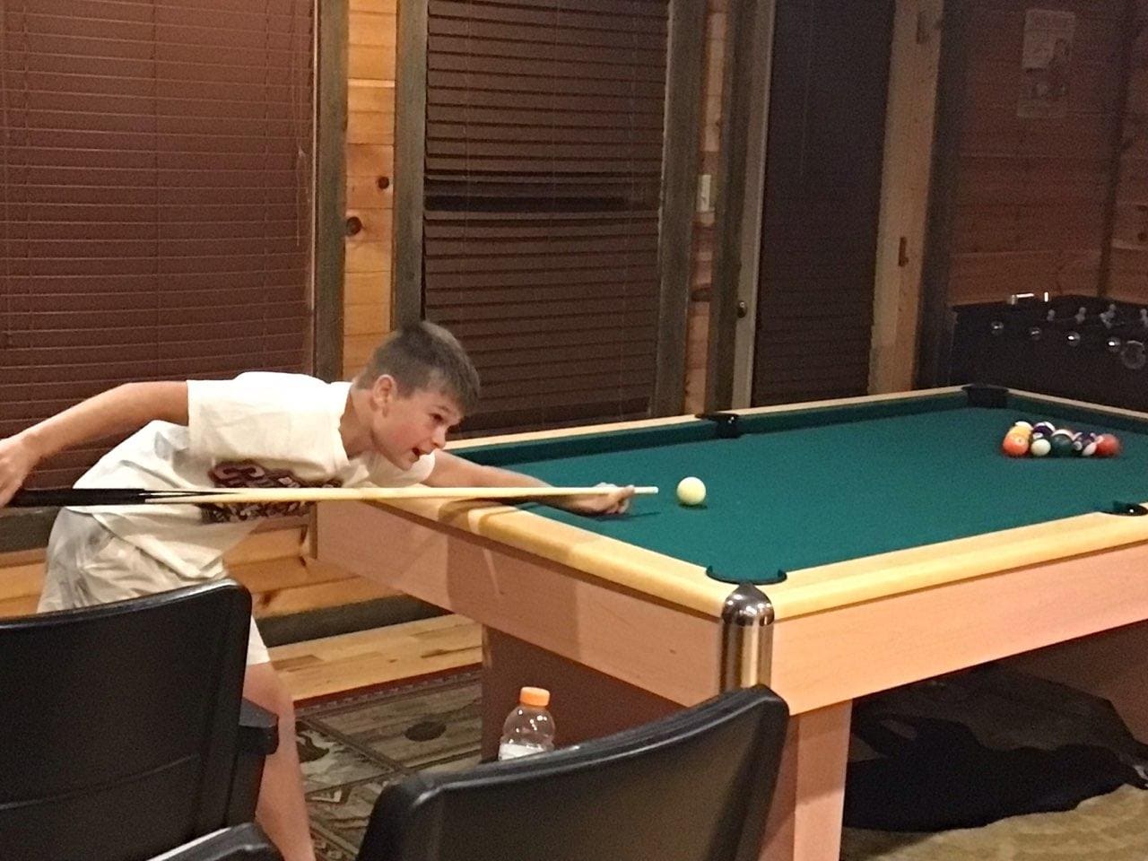 The pool table was busy all of the time.
