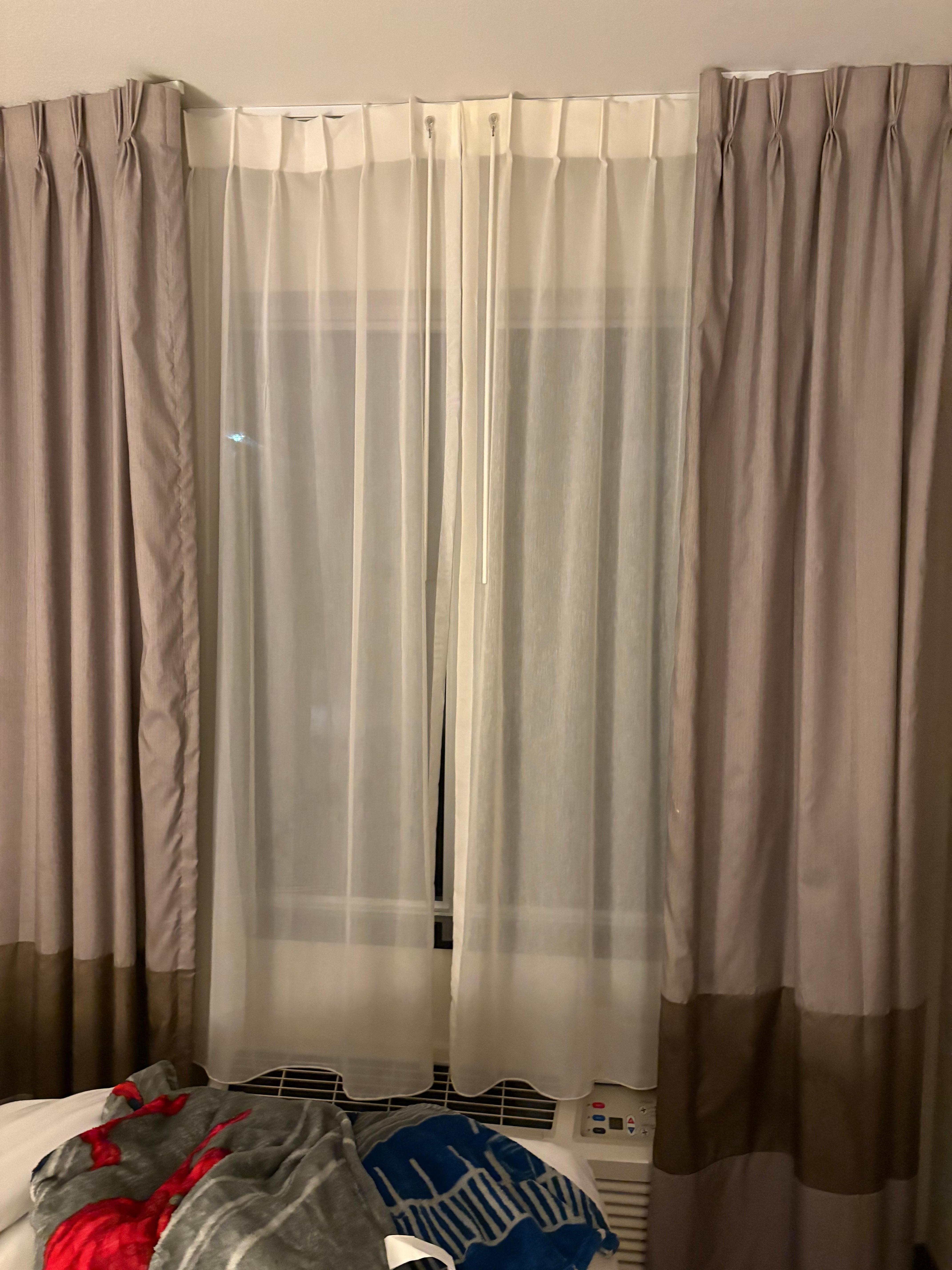 Curtain did not close so sunlight came straight through room did not know blinds were behind sheet curtain even when I tried calling the front desk
