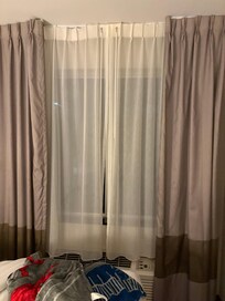 Curtain did not close so sunlight came straight through room did not know blinds were behind sheet curtain even when I tried calling the front desk