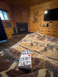 Bed with fireplace in background.