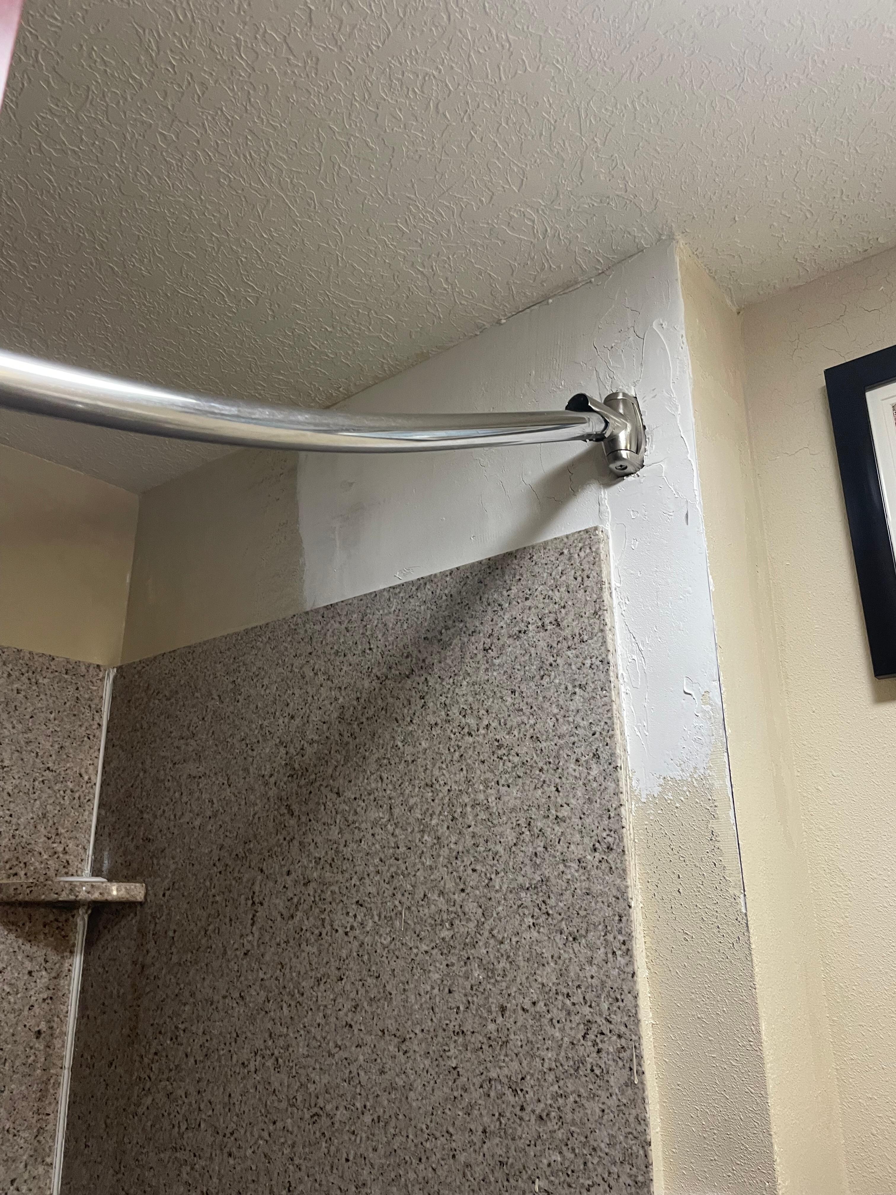 Shower rod holders were crumbling, so rod bowed down instead out out making the curtain hang only in the middle