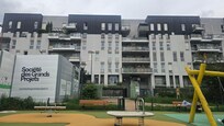 Apartment building across from a park.