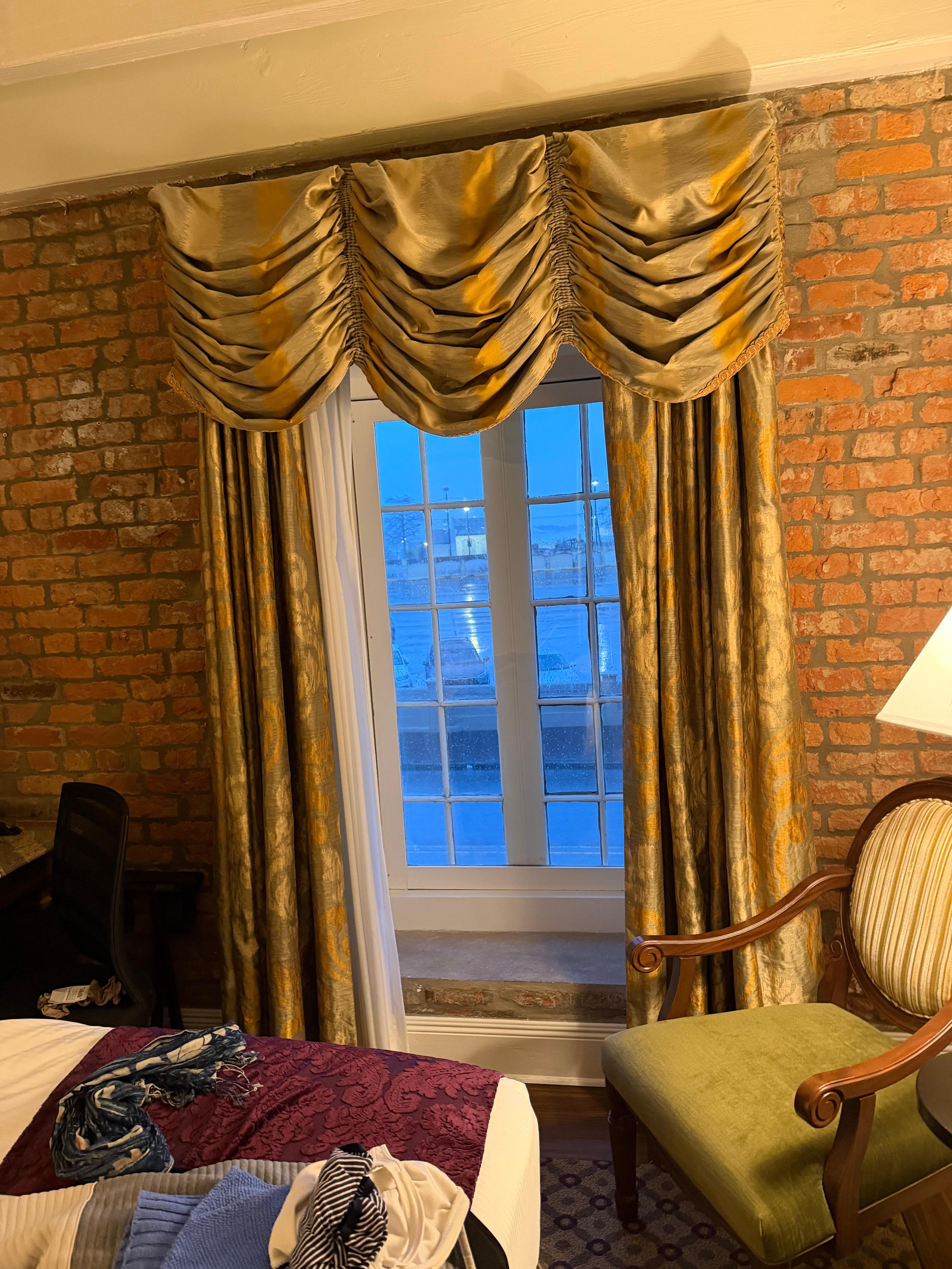 Bedroom curtains, and brick walls.