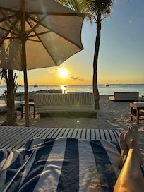 Sunsets every evening. The staff moves the umbrella throughout the day!