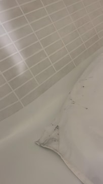 Dirty floor with black mold like substance in shower