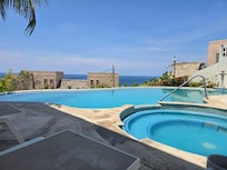 Relax in the pool area with this view of the ocean