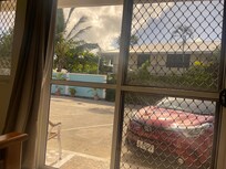 The front of our hotel room #4 including my rental car from Samoana