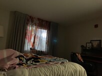 Light shinning in room from parking lot next to hotel