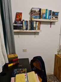 No TV, but plenty to read, and a table to work at.