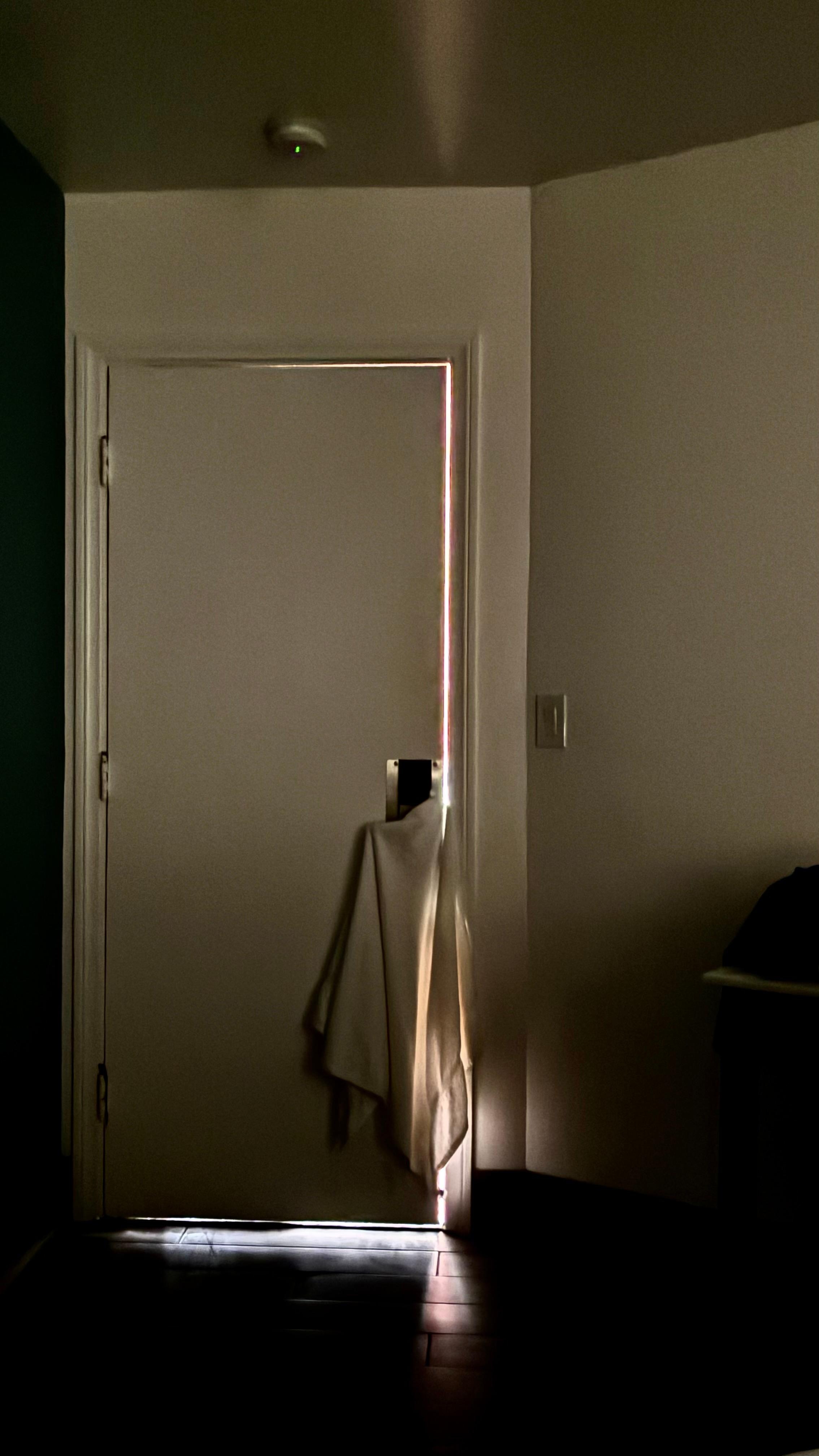 We tried to hang a towel on the doorknob to block some light.