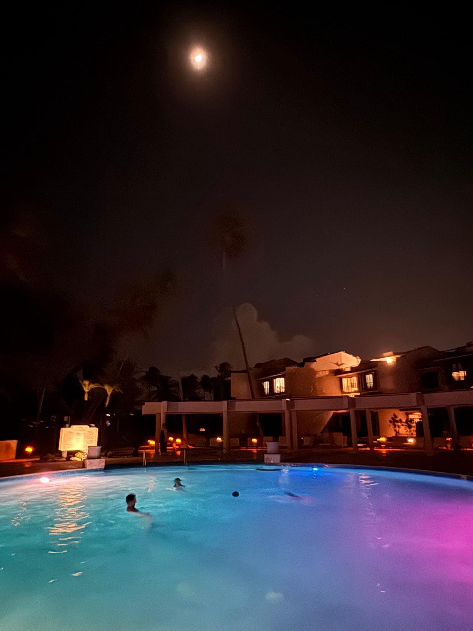 Enjoying the pool at the complex, under moonlight