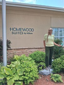 I am in front of the hotel admiring the beautiful landscape.