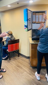 Water is filled in empty orange cans and water feels orange flavor.