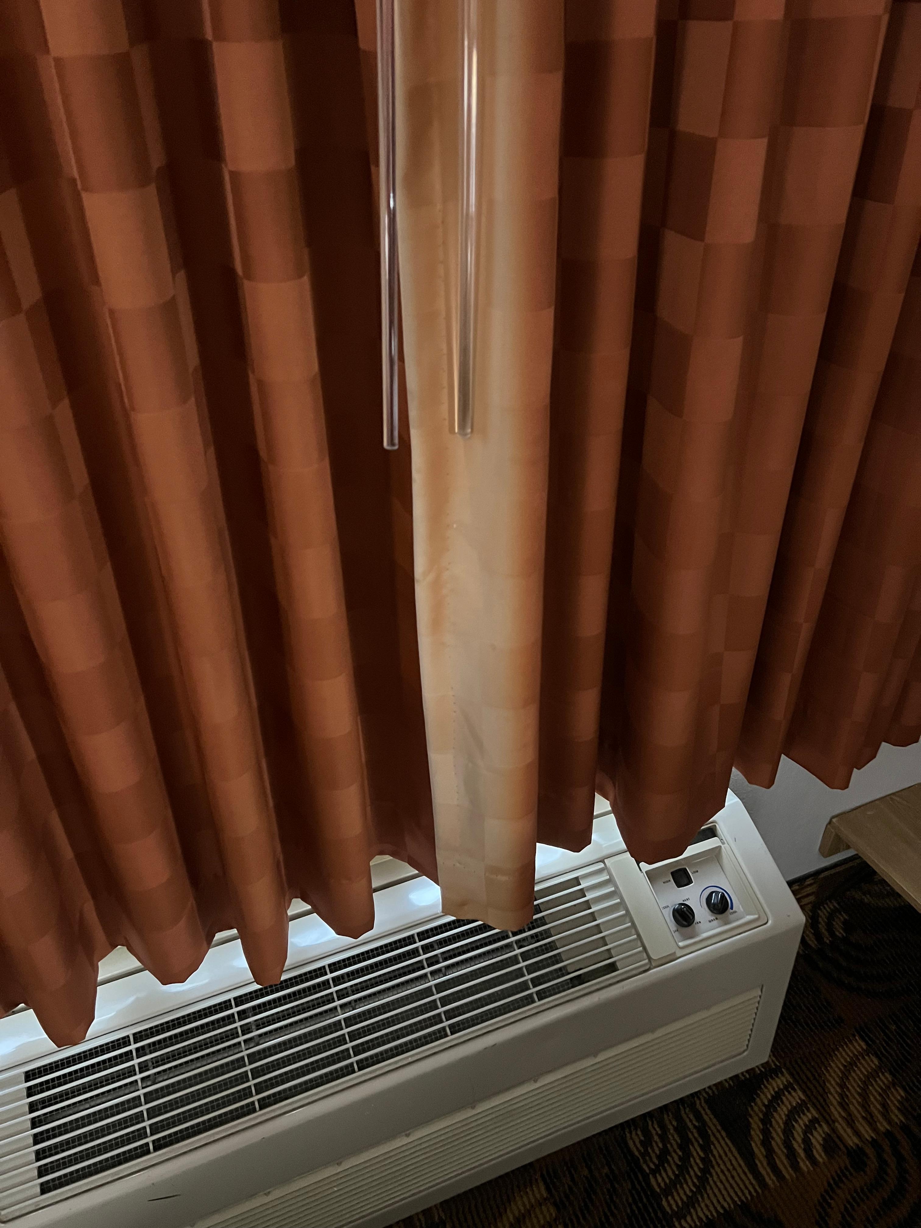 Old AC, faded curtains