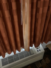 Old AC, faded curtains