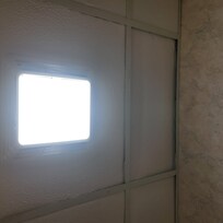 Open ceiling tiles in the bathroom