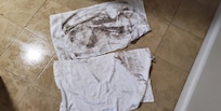 Towels after wiping fake wood and tiled floors. Note the glistening tile due to dampness.