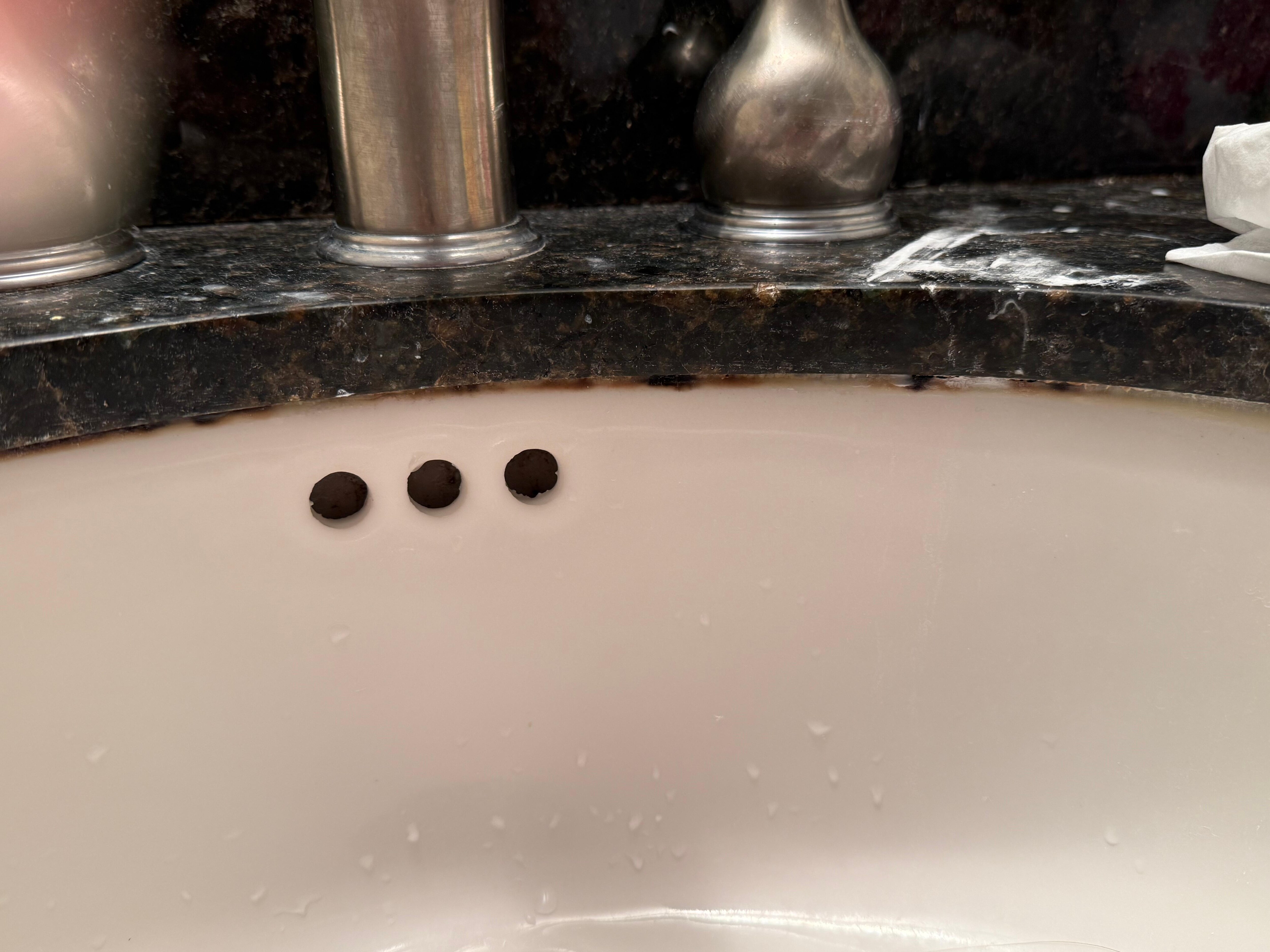 Mouldy grout around rim of sink