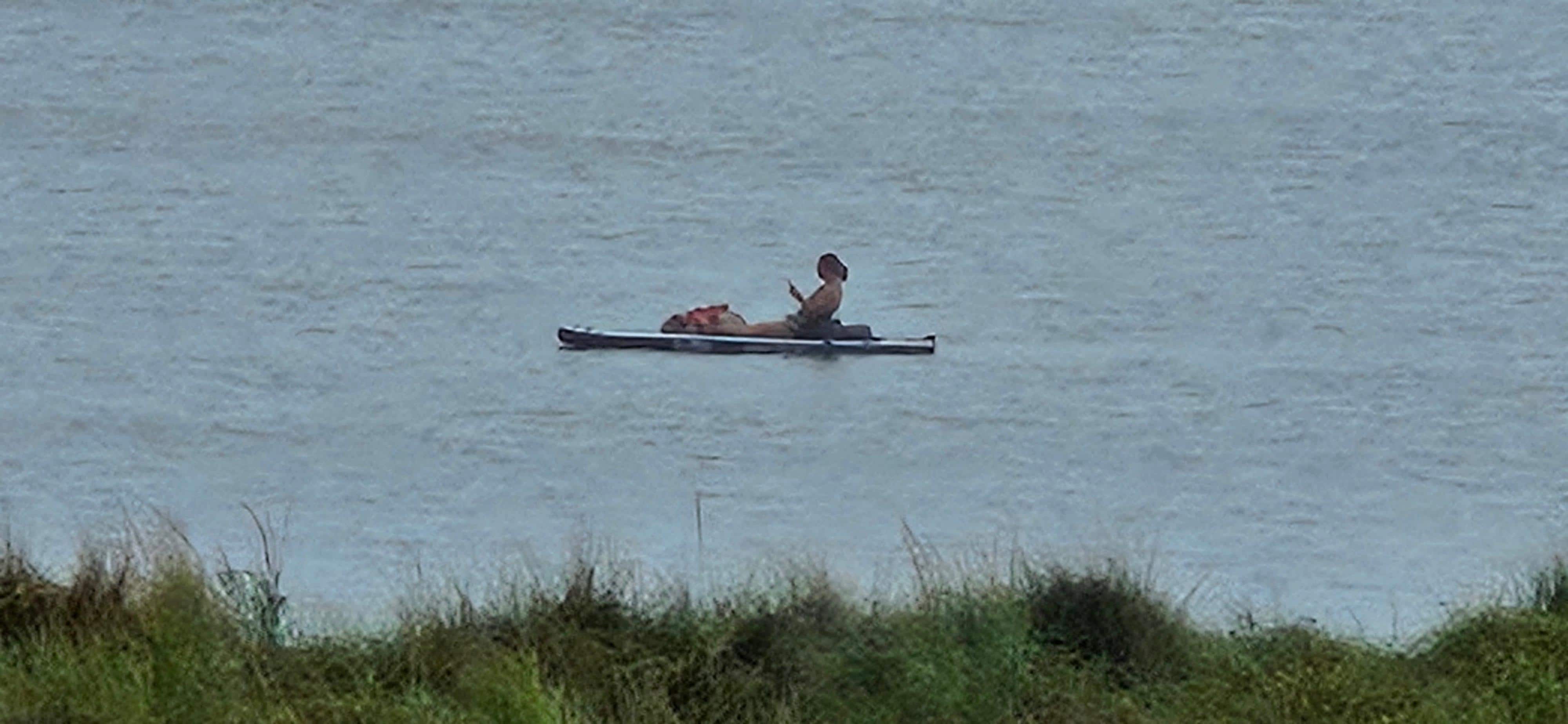 Our daughter on SUP while sitting with her dog