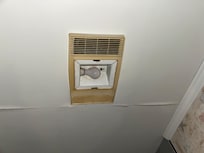 Cracks in bathroom ceilings with old brown looking fans