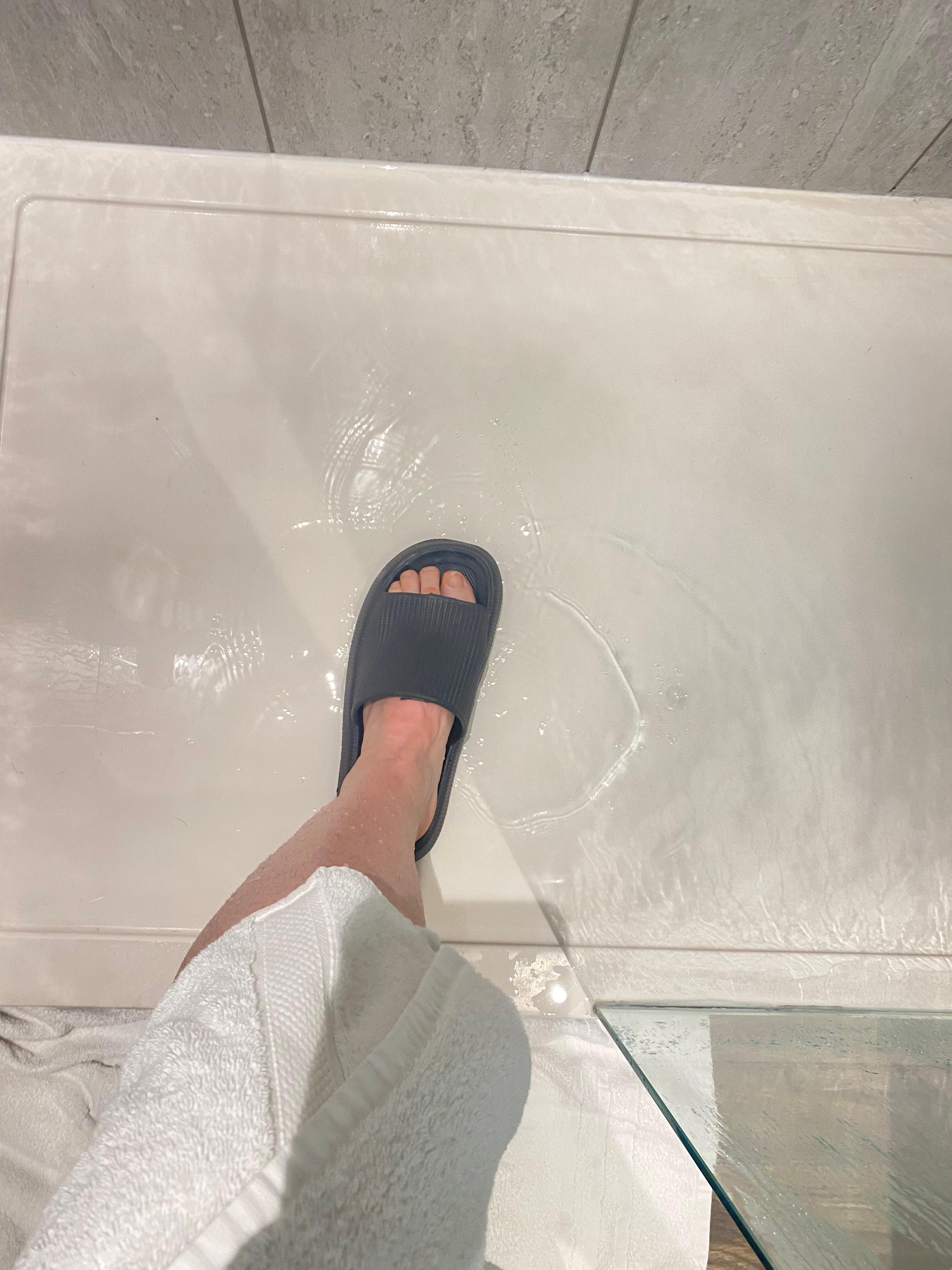 Standing in water. Shower not on but not draining. Video I took shows it better 