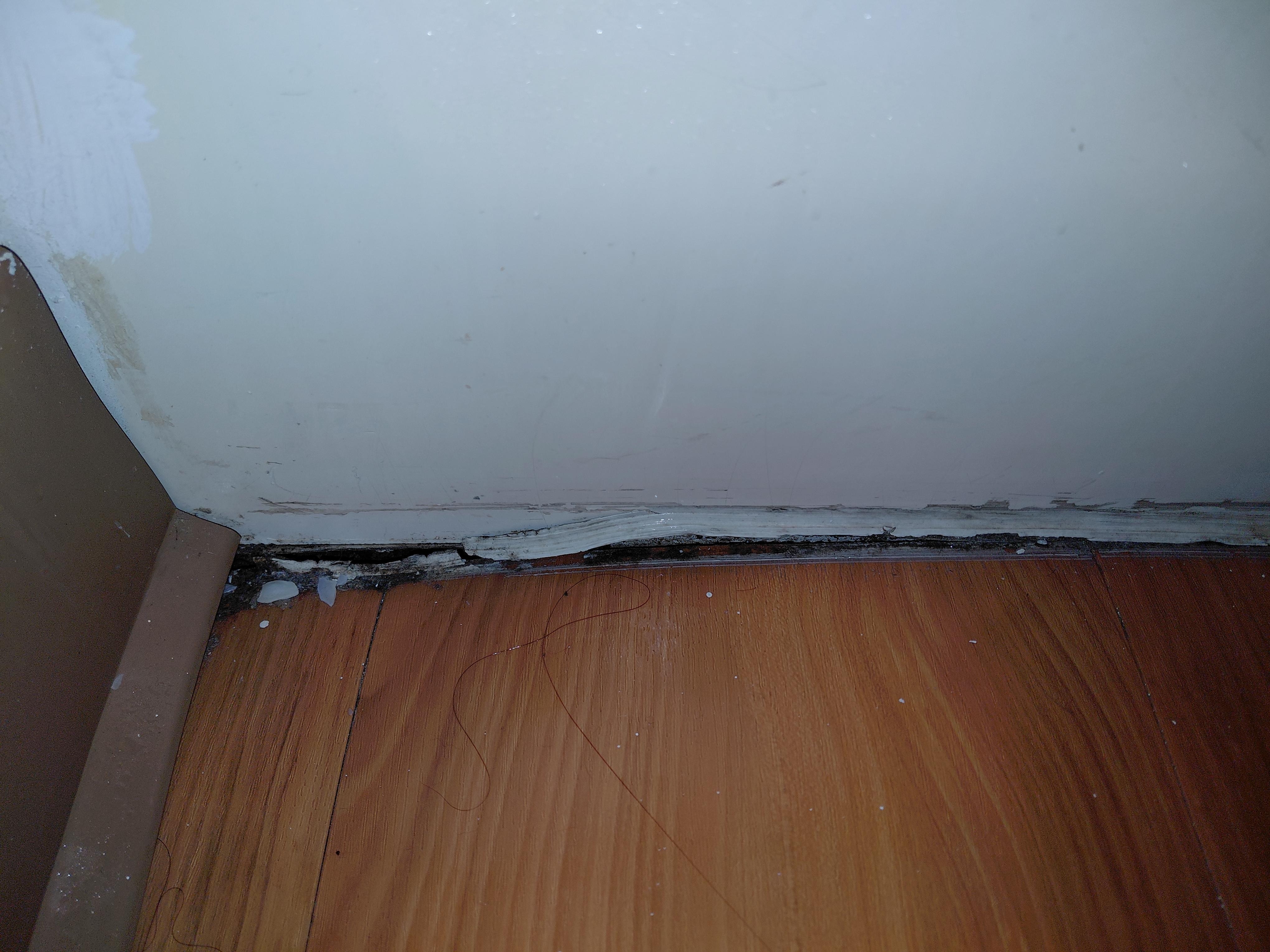 Hole in floor next to the bathtub 