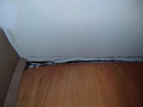 Hole in floor next to the bathtub