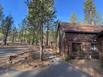The beautiful side/front view of the cabin from the driveway where you can park.