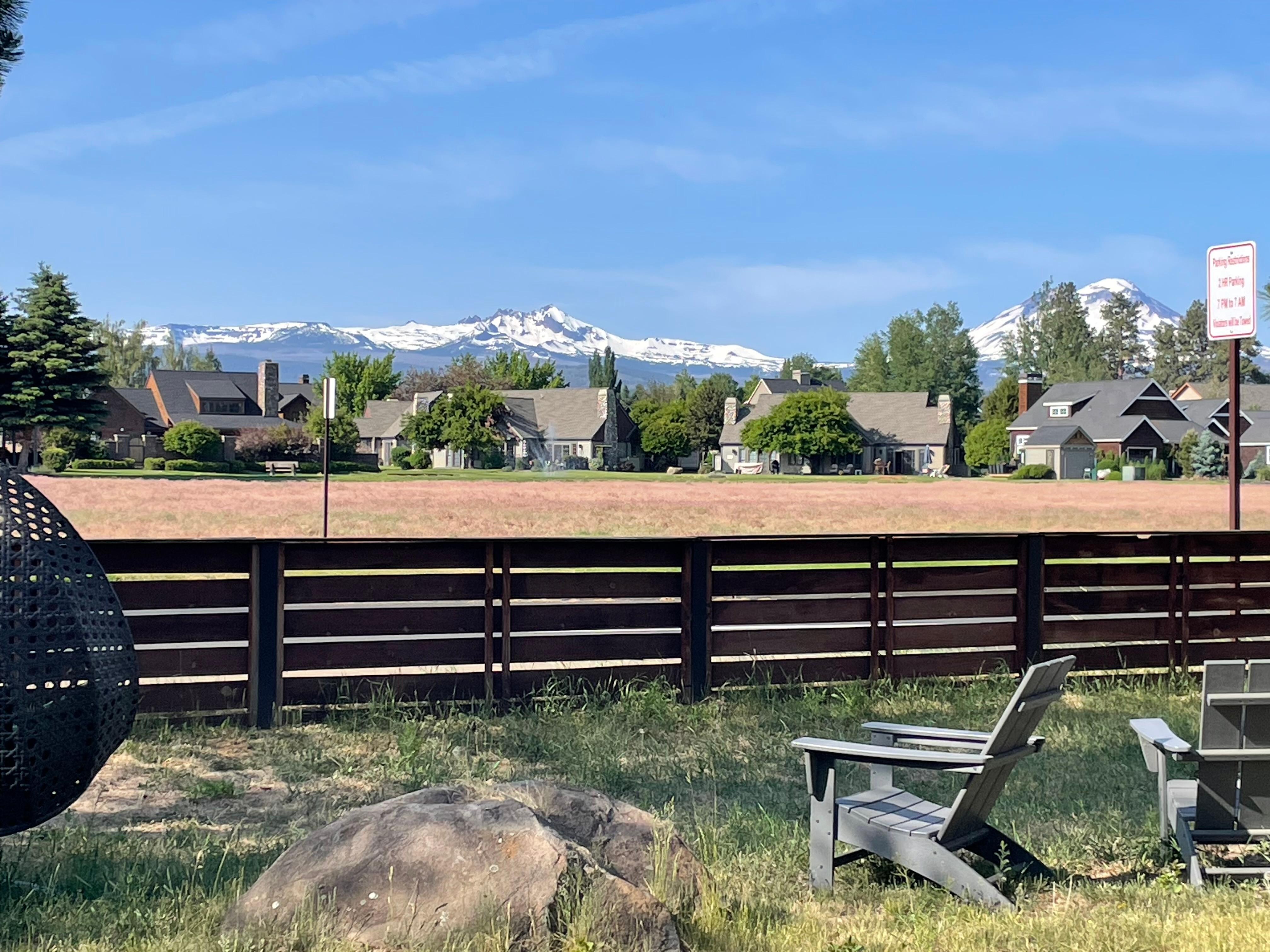  View from back of complex with various seating opens and picnic table.