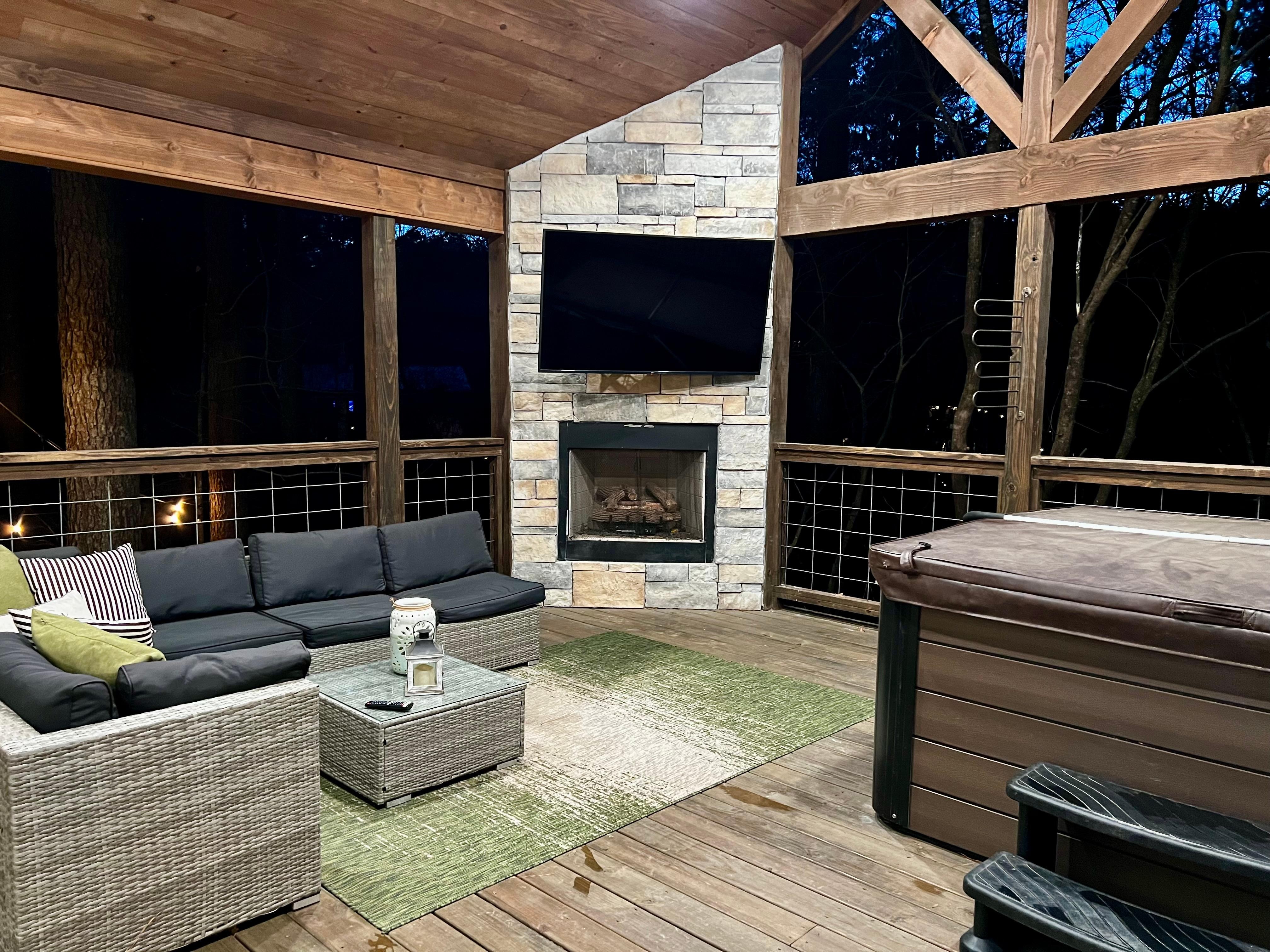 A bedroom door opens up to this magnificent outdoor space with hot tub, fireplace, and big screen television. Perfection!
