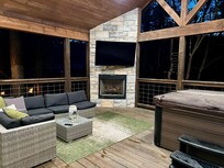 A bedroom door opens up to this magnificent outdoor space with hot tub, fireplace, and big screen television. Perfection!