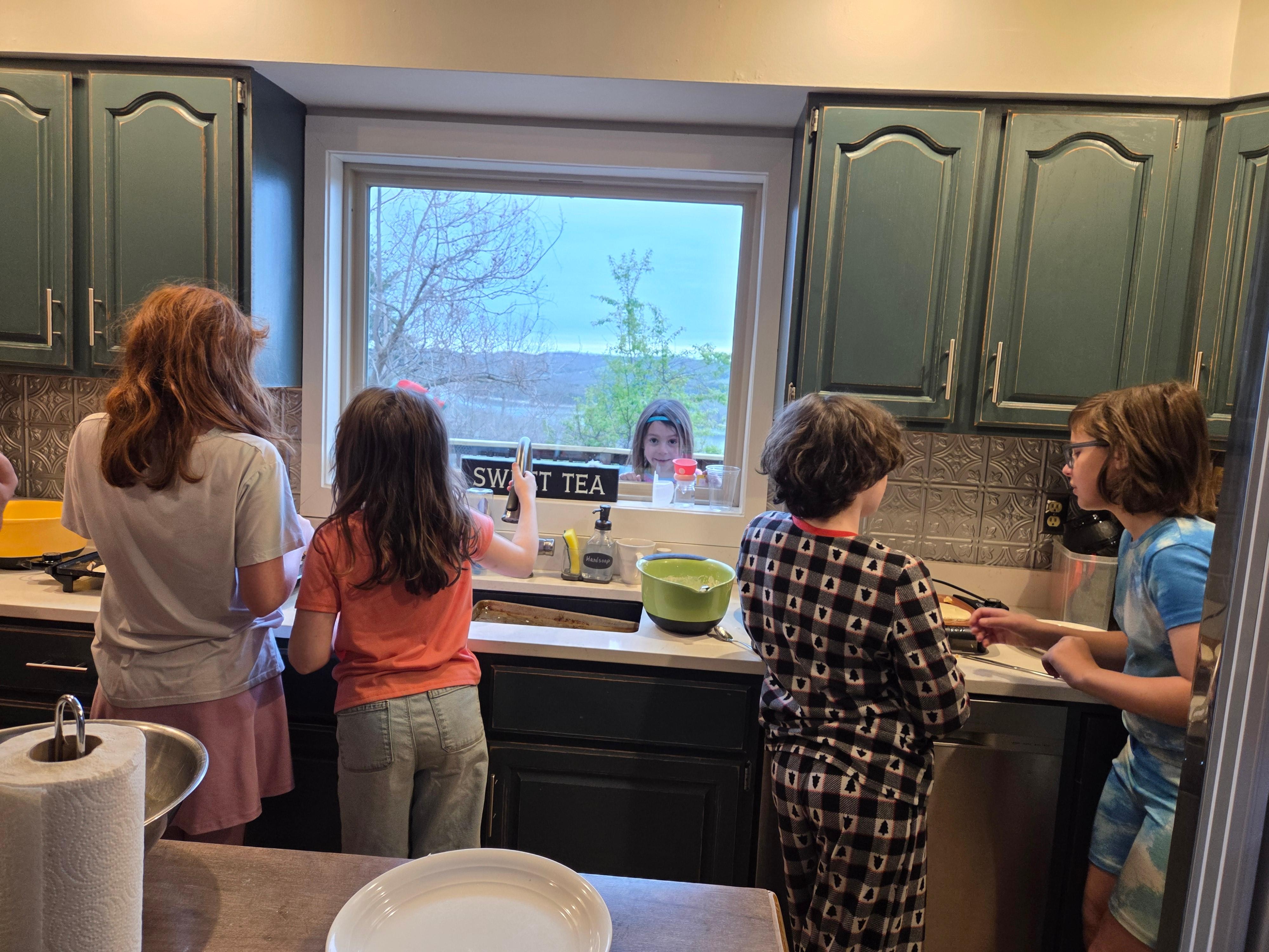 Cousins making breakfast for the family with Grammie 